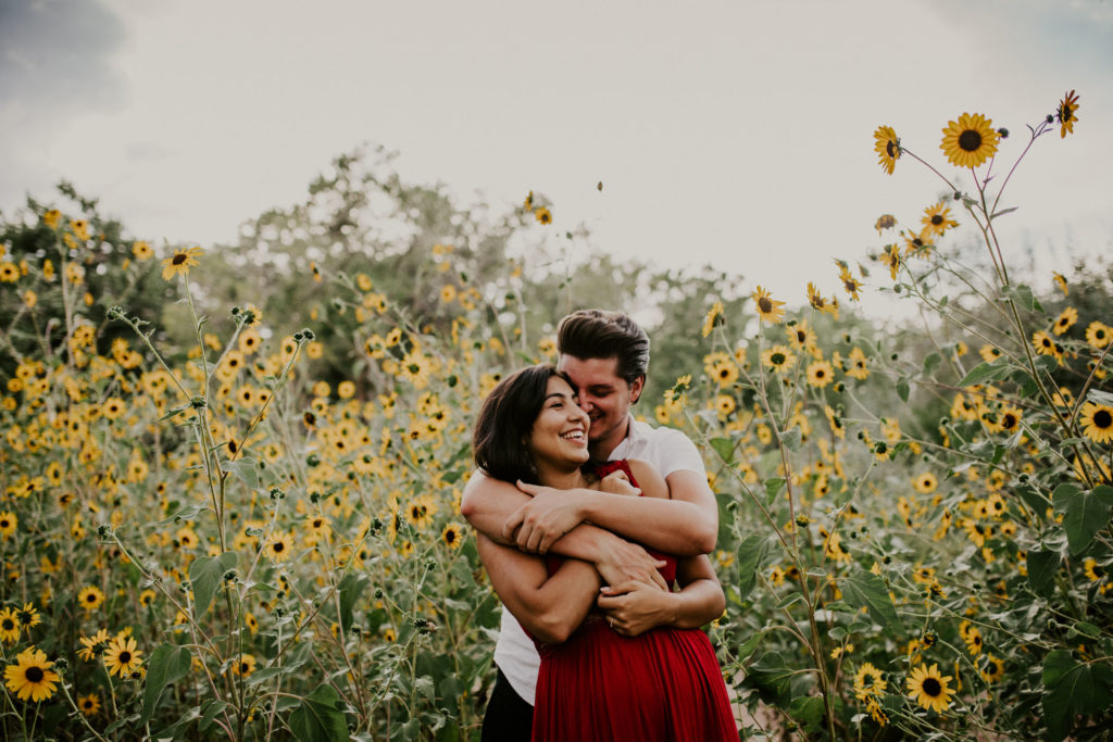 couple hugging in a sunflower field