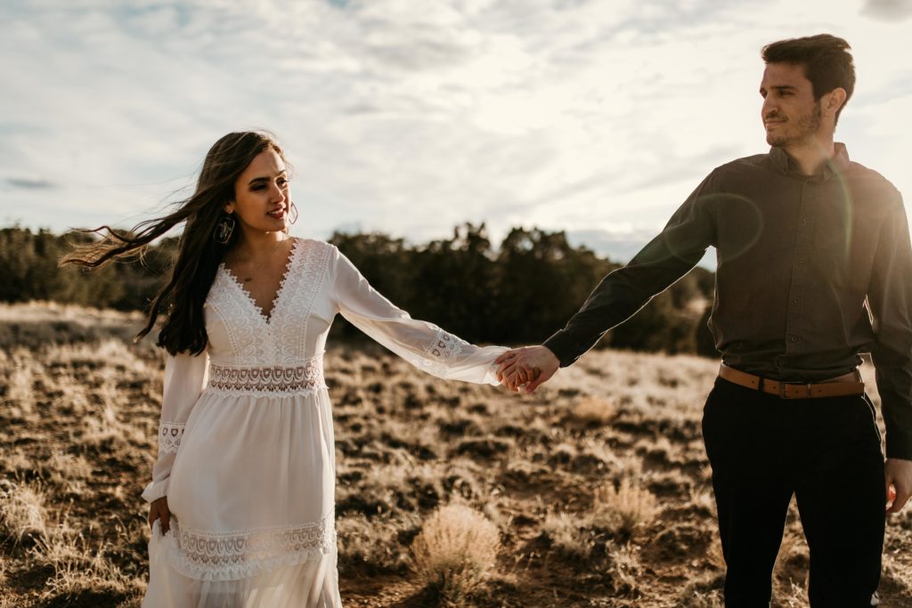 husband and wife walking in the desert