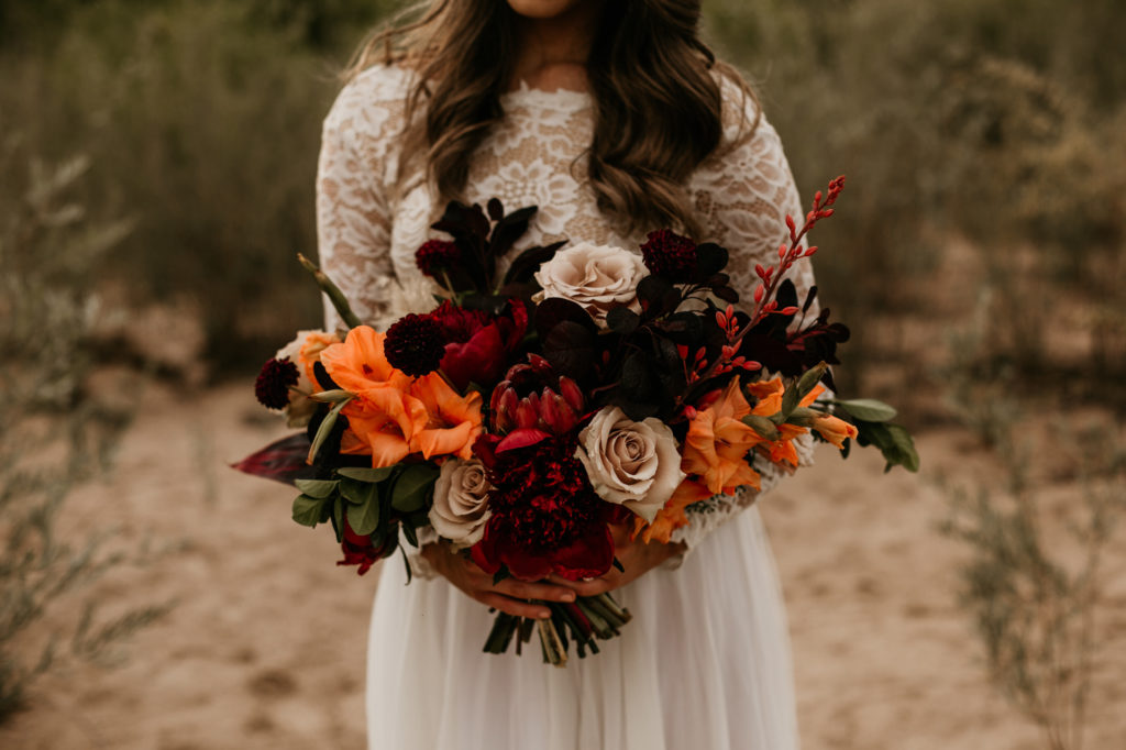 bride holding bouquet in the desert