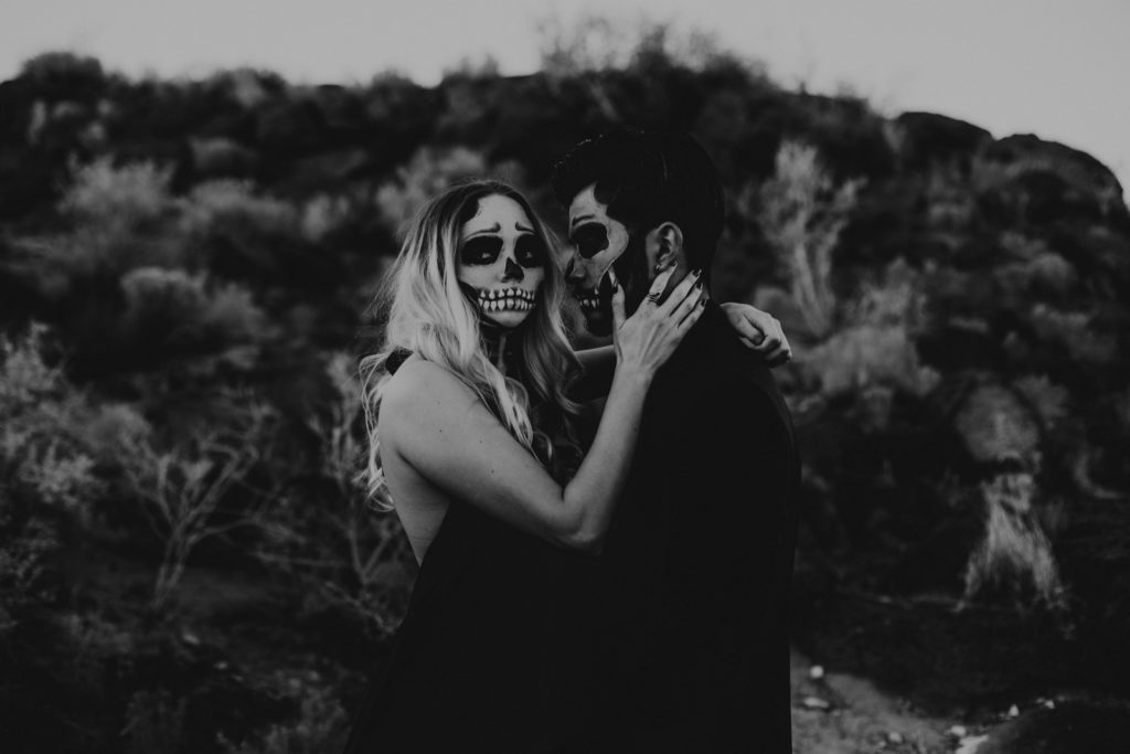 Black and white photo of a couple with skeleton makeup for a Halloween styled shoot