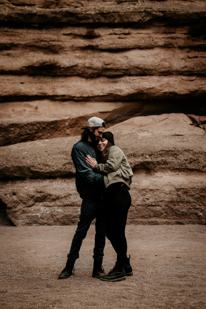 husband and wife holding each other in a New Mexico canyon