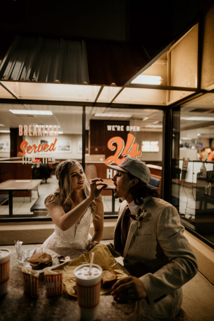 newlyweds eating burgers at whataburger together after their wedding