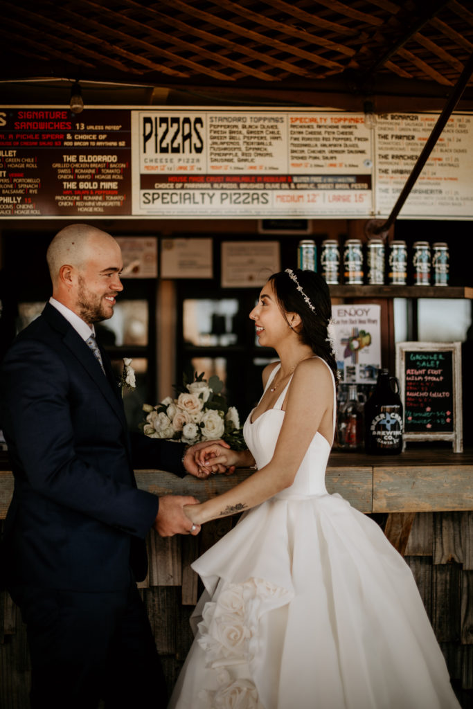 newlyweds standing together at a bar in Santa Fe after ceremony