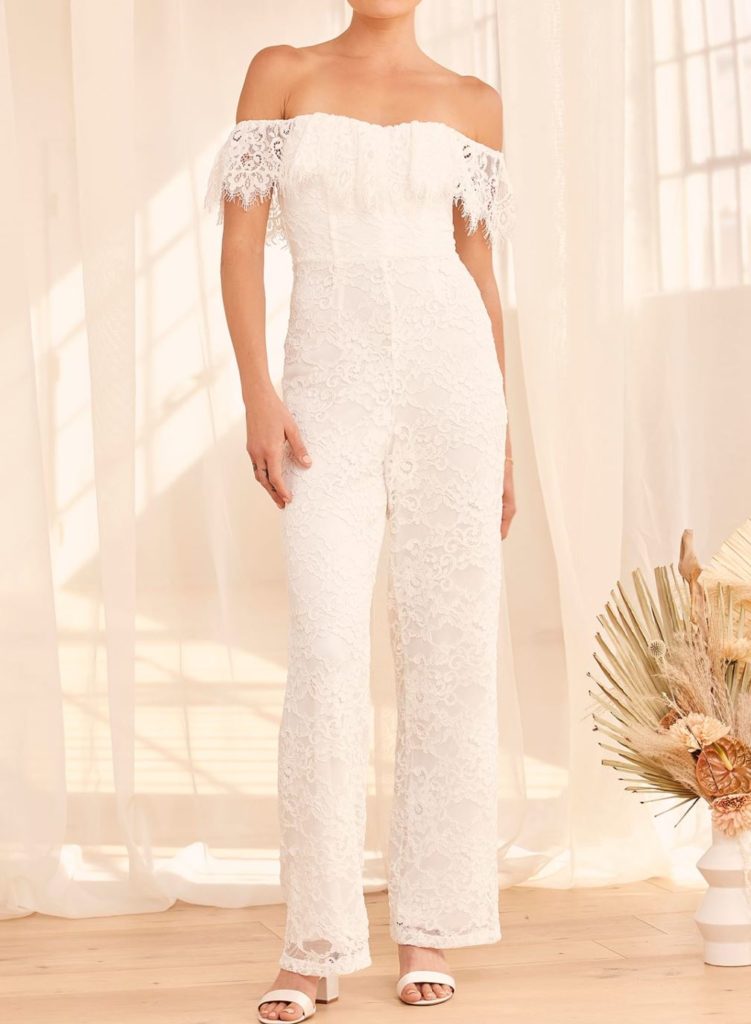 woman wearing a white lace bridal jumpsuit