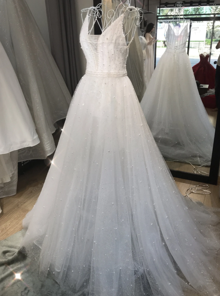 A-line pearl wedding dress on a mannequin