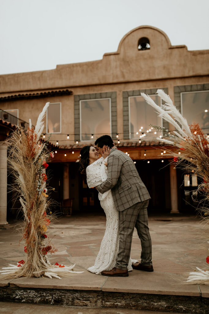 Bride and groom kissing for the first time after their elopement ceremony.