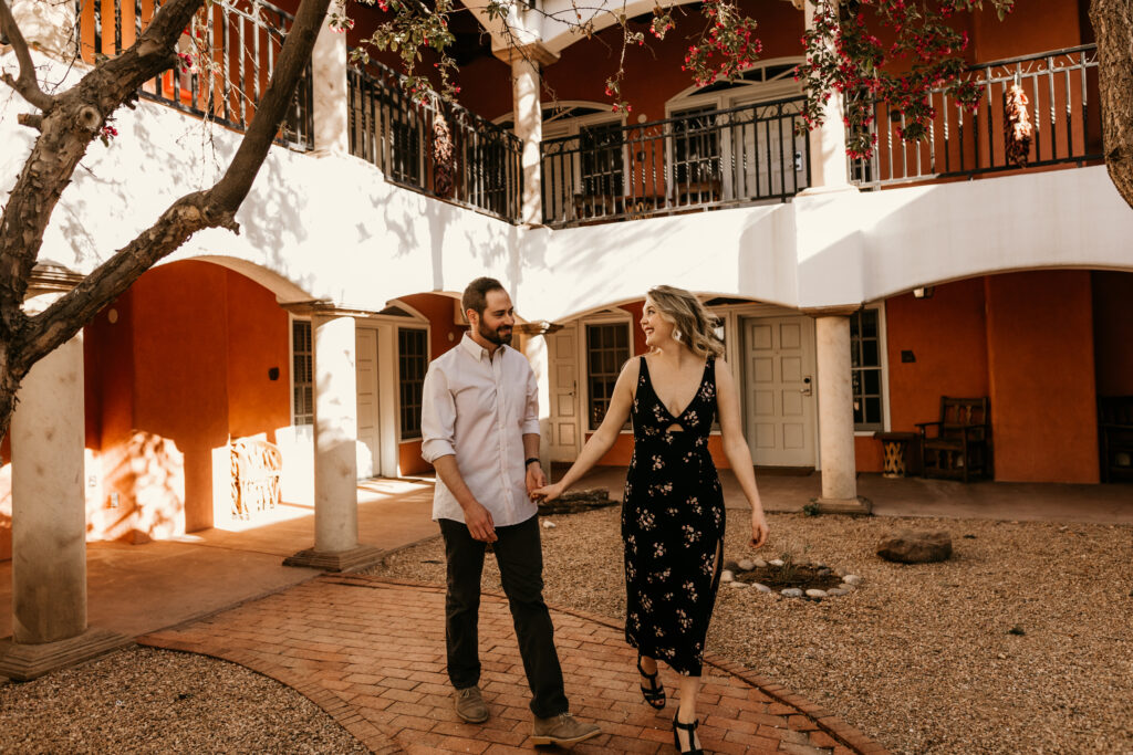 Man and woman walking through a courtyard together at a venue in Santa Fe, New Mexico.